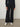 Person wearing the Parker Pant, a black corduroy plaid pant by Margaret O'Leary.
