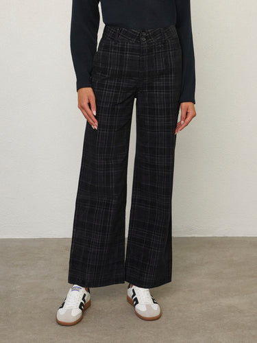 Person wearing the Parker Pant, a black corduroy plaid pant by Margaret O'Leary.