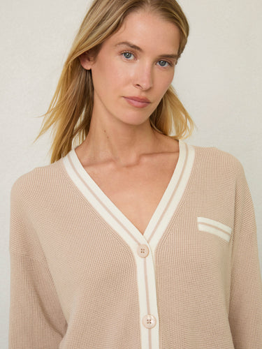 Person wearing the Santa Rosa Cardi a beige cardigan with white accents by Margaret O'Leary.