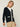 Person wearing the Santa Rosa Cardi a black cardigan with white accents by Margaret O'Leary paired with khaki pants