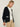 Person wearing the Santa Rosa Cardi a black cardigan with white accents by Margaret O'Leary paired with khaki pants