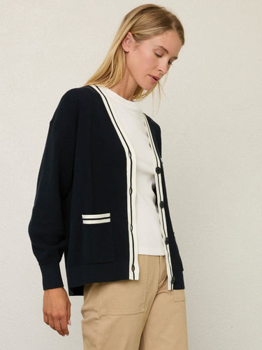 Person wearing the Santa Rosa Cardi a black cardigan with white accents by Margaret O'Leary paired with khaki pants