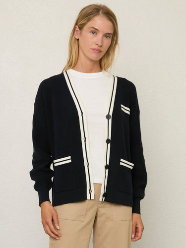 Person wearing the Santa Rosa Cardi a black cardigan with white accents by Margaret O'Leary paired with khaki pants