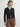 Person wearing the St. Carmel a black waffle knit zip up polo by Margaret O'Leary paired with brown pants.