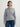 Person wearing the Tahoe Zip Up, a grey tneck cashmere zip up by Margaret O'Leary paired with blue jeans.