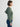 Person wearing the Thermal Hoodie a green waffle knit zip up hoodie by Margaret O'Leary paired with blue jeans.