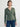 Person wearing the Thermal Hoodie a green waffle knit zip up hoodie by Margaret O'Leary paired with blue jeans.