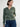 Person wearing the Thermal Hoodie a green waffle knit zip up hoodie by Margaret O'Leary paired with blue jeans.