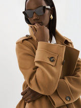 Woman wearing the Margaret Wool Trench Coat in Camel.