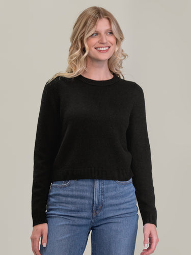 Woman wearing the cashmere pullover in black by Margaret O'Leary.