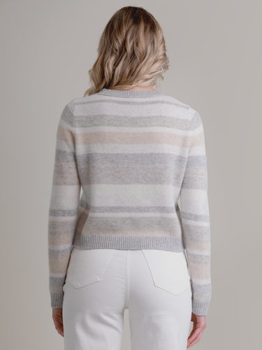 Woman wearing the cashmere pullover in neutral stripes by Margaret O'Leary.