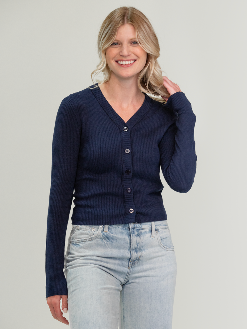 Woman wearing the Anya Rib Cardi in Navy by Margaret O'Leary.