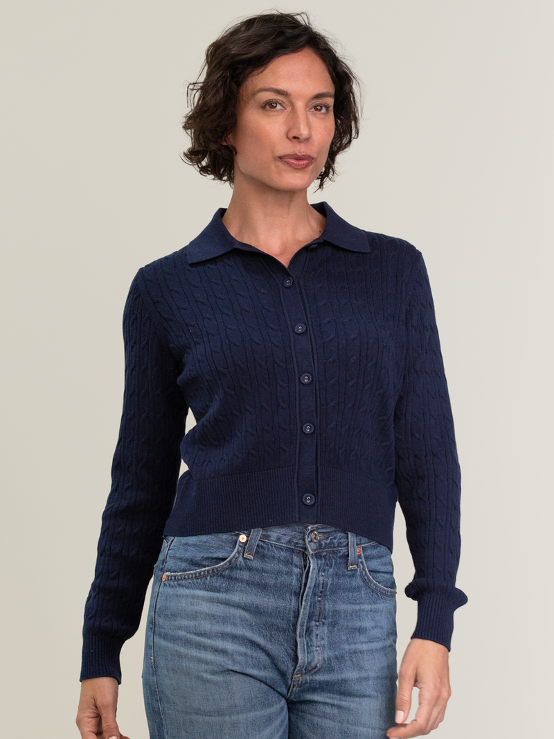 Woman wearing the Emmylou Cable Cardi in navy by Margaret O'Leary.