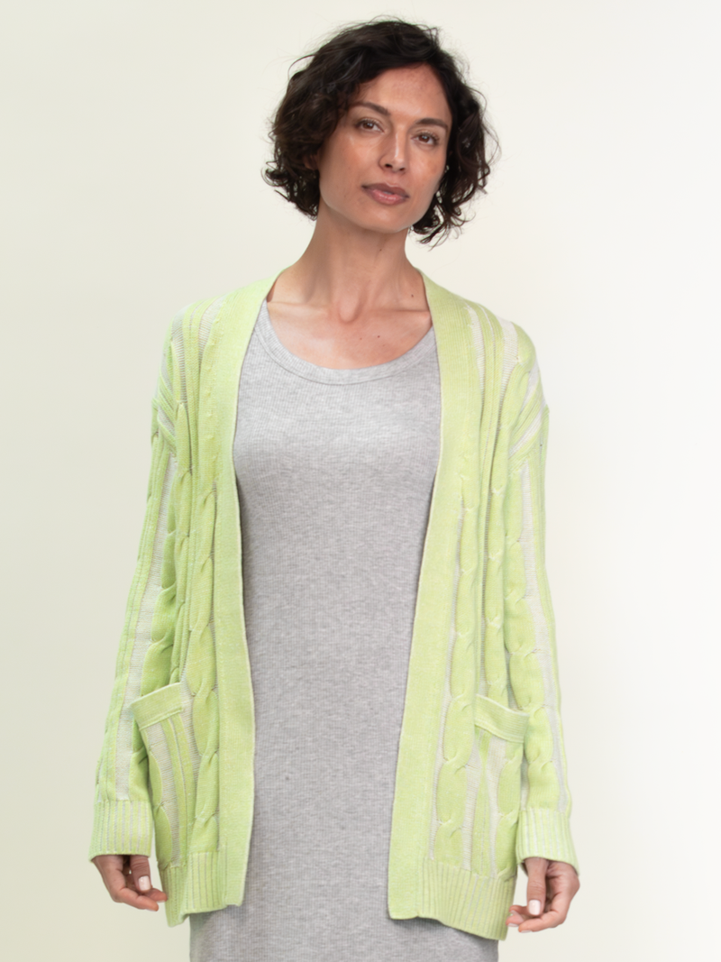 Woman wearing the Nina Cable Cardi in Kiwi by Margaret O'Leary.