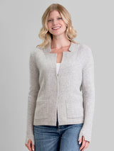 Woman wearing a fitted grey cashmere jacket.
