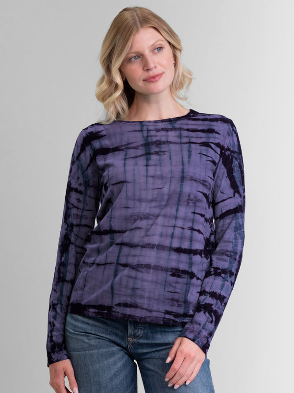 Woman wearing a purple long sleeve tie dye tee.