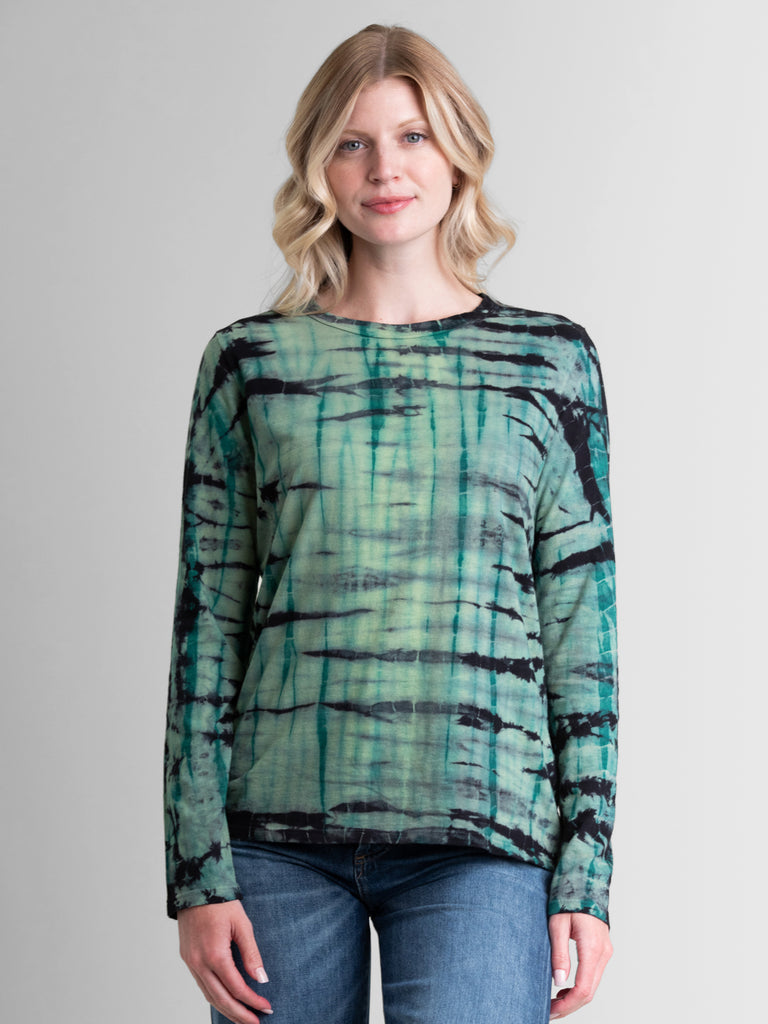 Woman wearing a green long sleeve tie dye tee.