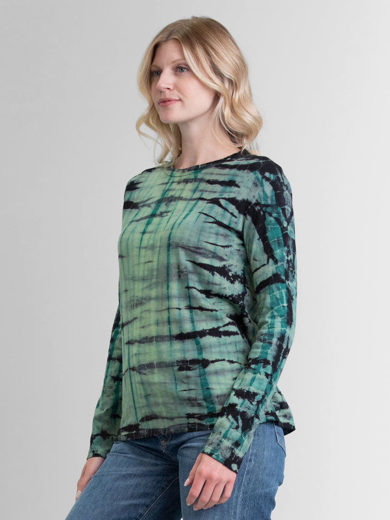Woman wearing a green long sleeve tie dye tee.