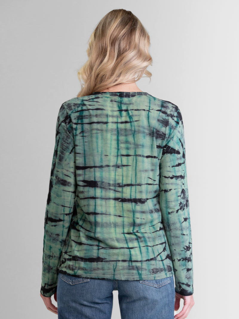 Woman wearing a green long sleeve tie dye tee.
