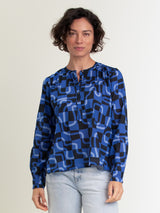 Woman wearing an abstract blue henley top.