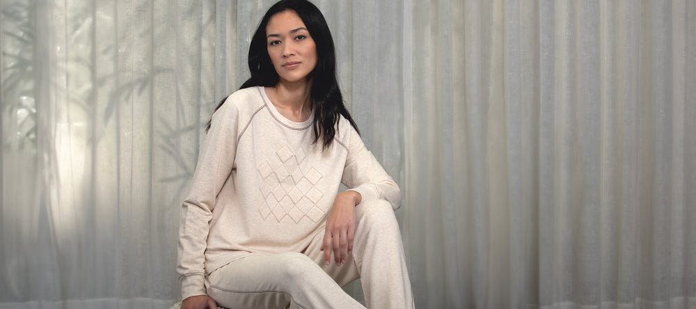 A woman wearing a lounge set by Margaret O'Leary.