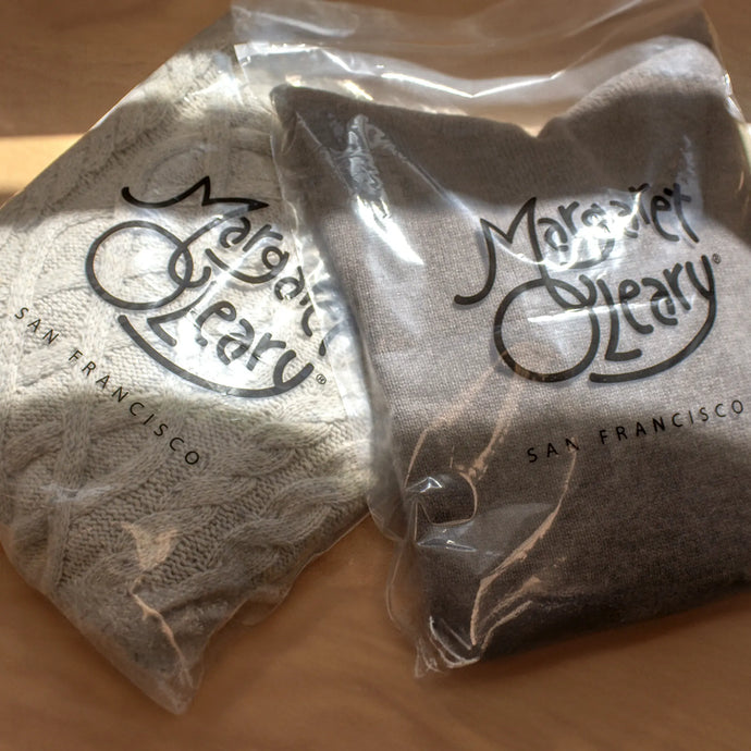 2 reusable zip bags with Margaret O'Leary sweaters inside.