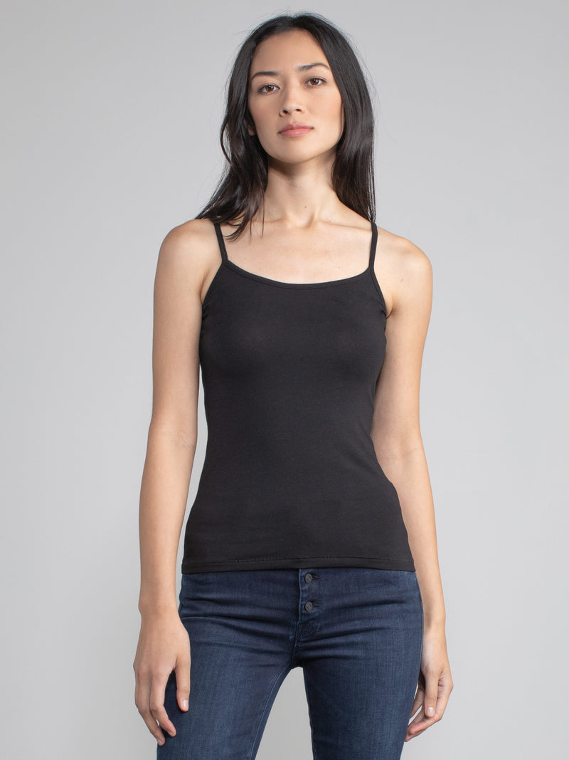 Portrait view of a woman wearing a fitted black camisole tank.