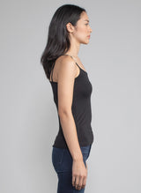 Side view of a woman wearing a fitted black camisole tank.