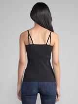 Back view of a woman wearing a fitted black camisole tank.
