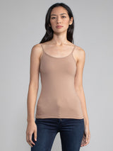 Portrait view of a woman wearing a fitted camel camisole tank.