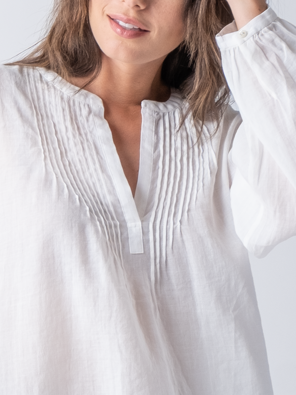 Closed up view of the pin tuck details near the neckline.