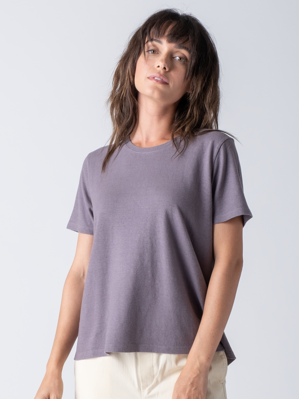 Portrait view of a woman wearing a mauve simple crew tee.