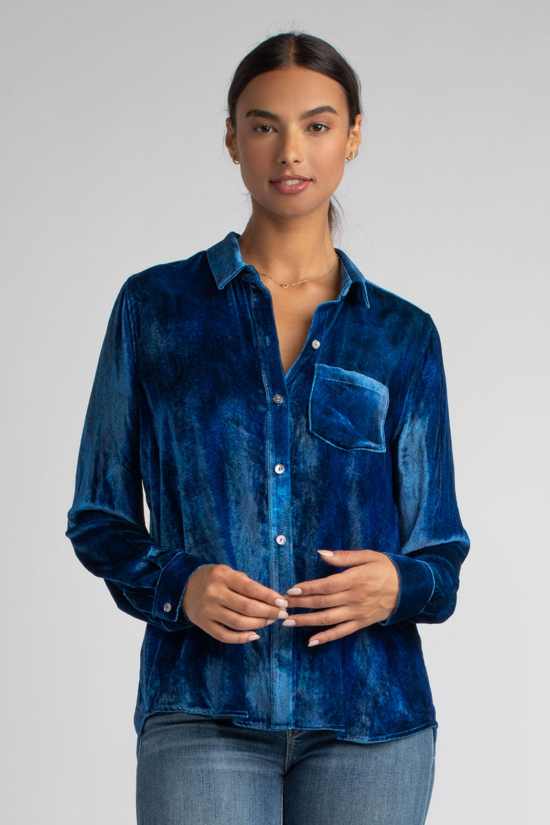 Model wearing a blue velvet shirt and a pair of jeans.