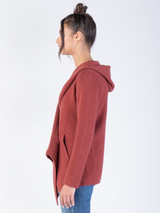 Woman wearing a red cashmere draped cardigan.