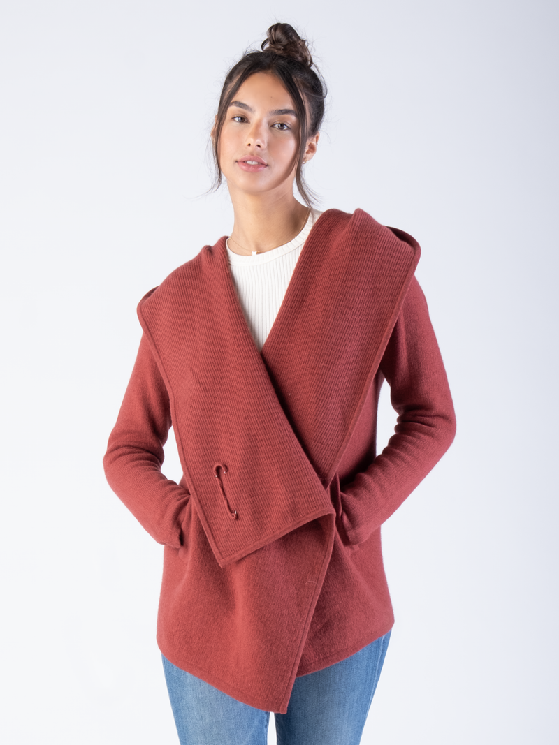 Woman wearing a red cashmere draped cardigan.