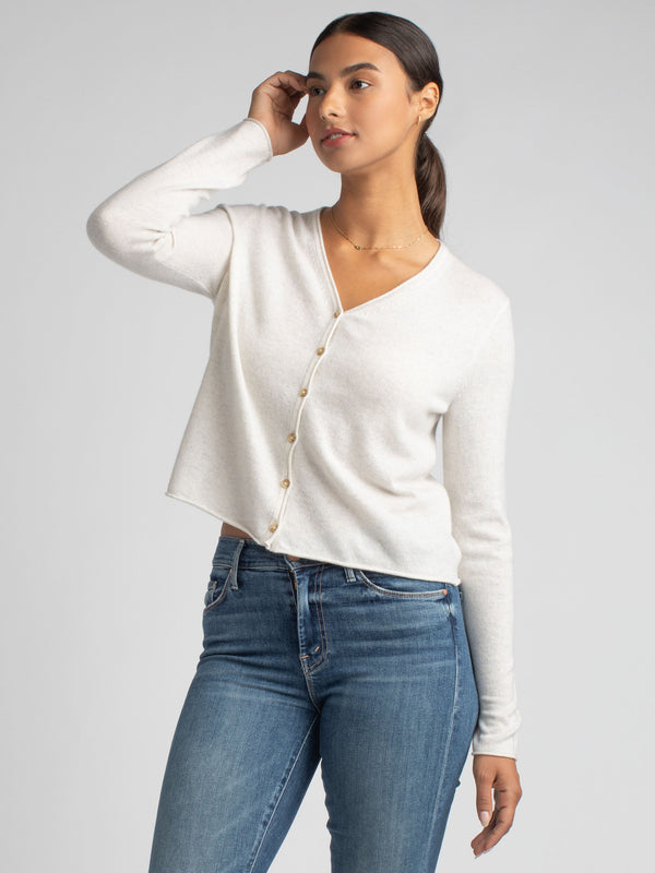 Model wearing a mist lightweight cashmere cardigan and a pair of jeans. 