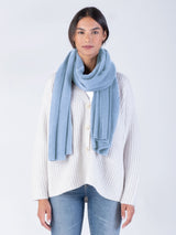 Model wearing the cashmere wrap in stonewash, tied loosely around her neck.