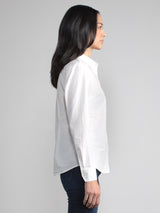 Side view of the model wearing a white shirt and a pair of jeans.