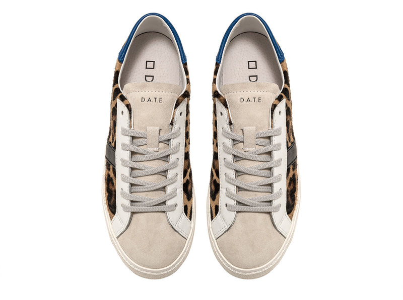 Low-top sneakers in brown animal print pony hair with a white suede tongue. 