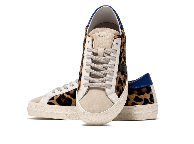 Low-top sneakers in brown animal print pony hair with a white suede tongue. 