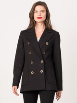 Female model wearing a black peacoat with eight gold circular buttons and two pockets.