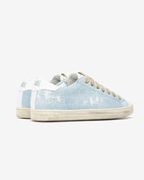 A pair of distressed denim lowtop sneakers, set against a bright white background.