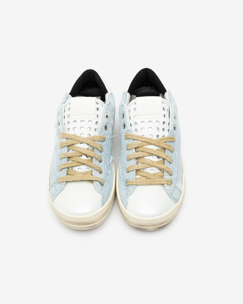 A pair of distressed denim lowtop sneakers, set against a bright white background.