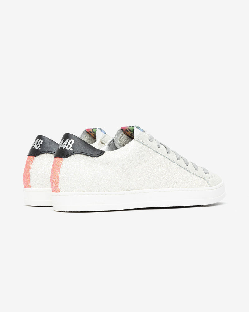 A pair of white and grey glitter sneakers, set against a bright white background.