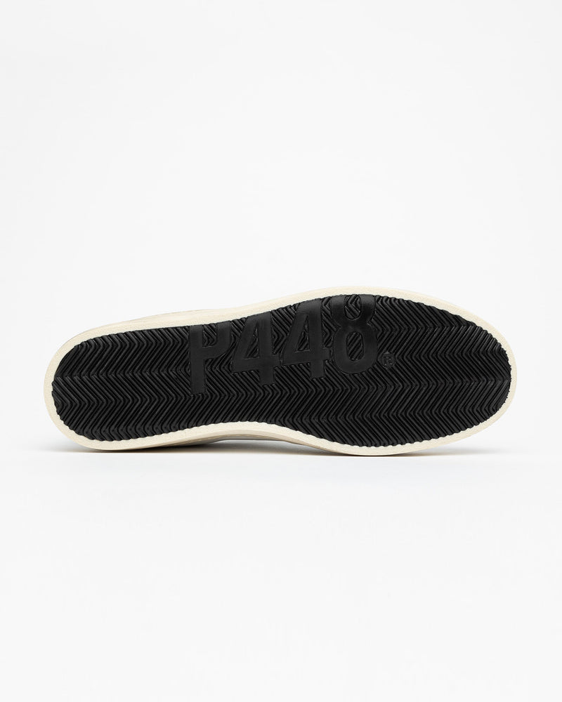 A view of the bottom sole of John Pearl sneaker, set against a bright white background.