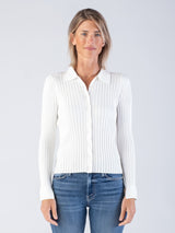 Model wearing a white ribbed fitted cardigan with a collar neckline and a pair of jeans.