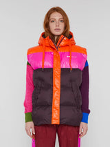 Front view of the model wearing the vest in bordeaux (bright orange, pink and brown) color.