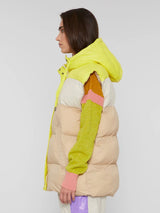 Side view of the model wearing the vest in panna (bright yellow, cream and beige) color.