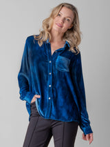 Model wearing a blue velvet shirt and a pair of pants.