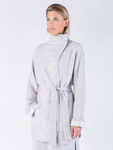 Model wearing a light grey two pockets jacket with a waist tie